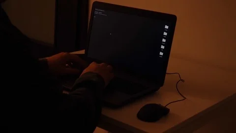 Developer coding in a dark room on a laptop when a glitch turns into code rai Stock Footage 120616922