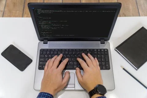 Developer coding on a laptop - top view Stock-Fotos