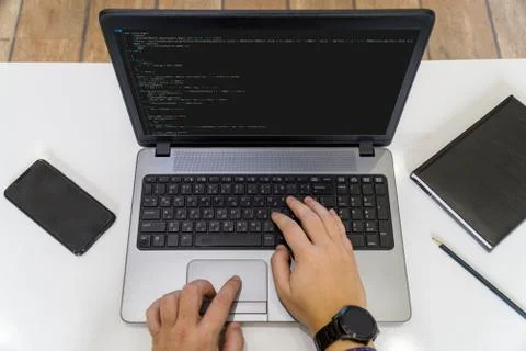Developer coding on a laptop - top view Stock Photos