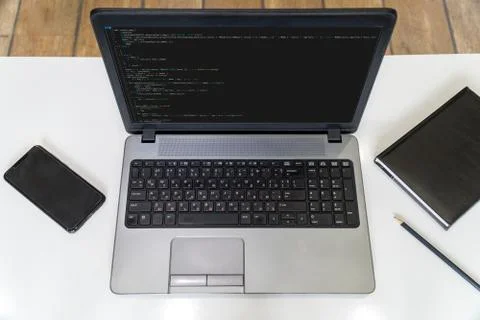Developer coding on a laptop - top view Stock Photos