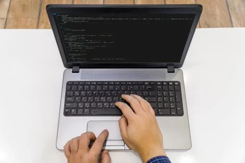 Developer coding on a laptop - top view Stock Photos
