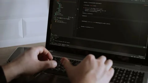 The developer is coding. The program code is visible on the screen. Work at home Stock Footage 148522705