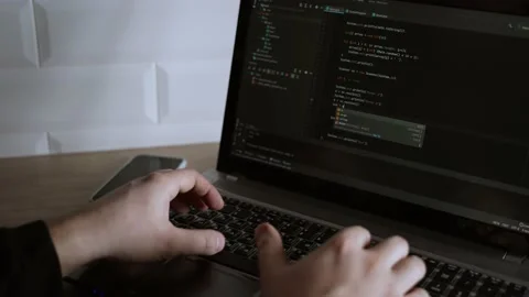 The developer is coding. The program code is visible on the screen. Work at home Stock Footage 148523225