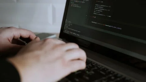The developer is coding. The program code is visible on the screen. Work at home Stock Footage 148523486