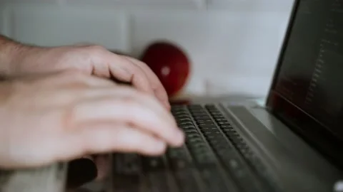 The developer is coding. The program code is visible on the screen. Work at home Stock Footage 148524533