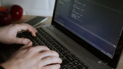 The developer is coding. The program code is visible on the screen. Work at home Stock Footage 148524639