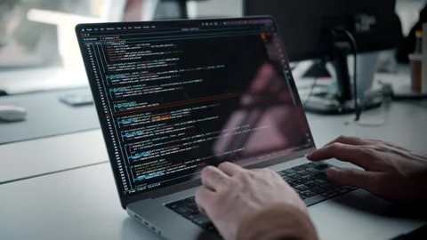 Developer coding in python on macbook laptop Stock Footage 245735898