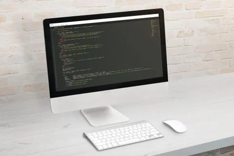 Developer computer with code on display. Clean office desk. Stock Photos
