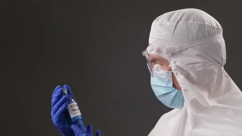 The developer of the coronavirus vaccine is holding transparent ampoule. The doc Stock Footage 144099689