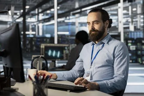 Developer in data center office doing software updates, verifying parameters Stock Photos