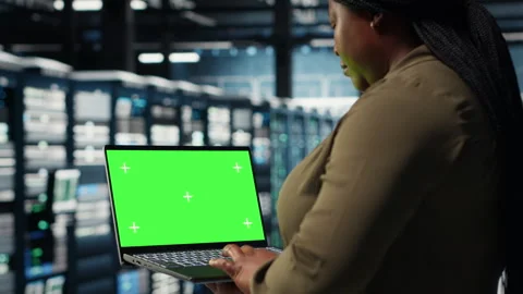 Developer in data center using green screen laptop to upgrade systems Stock Footage 317126015