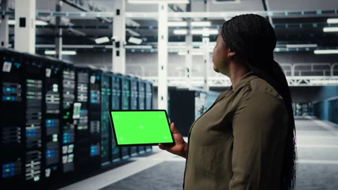 Developer in data center using isolated screen tablet to upgrade systems Stock Footage 317123880