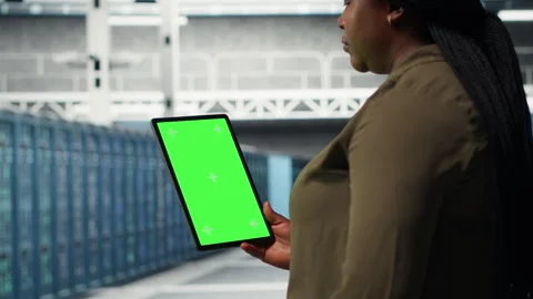 Developer in data center using isolated screen tablet to upgrade systems Stock Footage 317203151