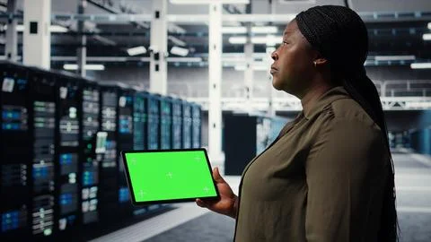 Developer in data center using isolated screen tablet to upgrade systems Stock Photos