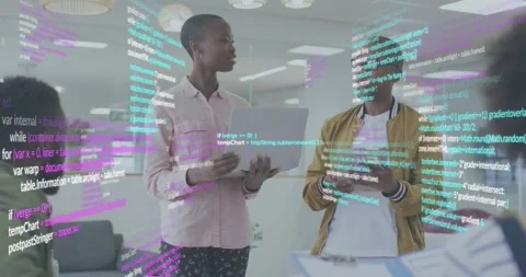 Developer demoing laptop feature initiating code overlay as colleague tapping Stock Footage 318070542