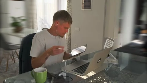 Developer at a desk uses a stylus on a tablet to mark code changes. Stock Footage 296221063