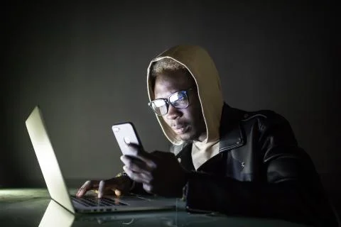 The developer is developing the software on his laptop in the night. the hack Foto stock