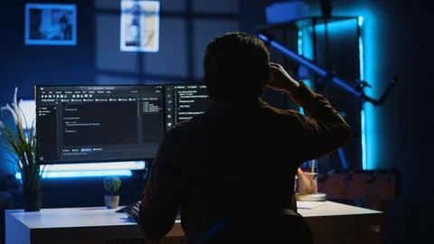 Developer drinking coffee while writing lines of code on computer 写真素材