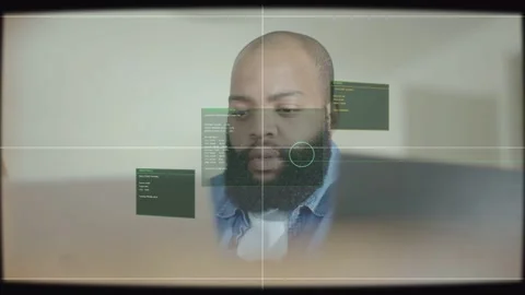Developer glancing at laptop, analyzing code, green UI panels appearing left mid Stock Footage 333601696
