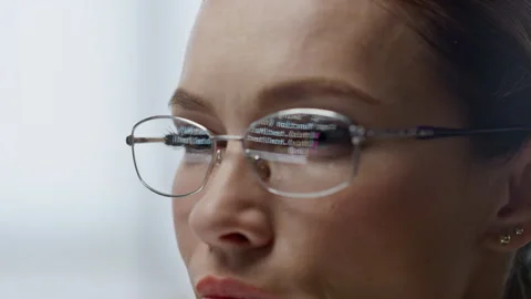 Developer glasses reflecting code lines closeup. Woman hacker programming app Stock Footage 242951506