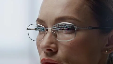 Developer glasses reflecting code lines closeup. Woman hacker programming app 스톡 사진