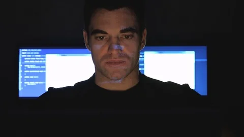 Developer hacker programmer working on computer in a data center while blue code Stock Footage 102926693