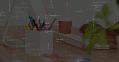 Developer hands typing code on keyboard at desk, featuring white pencil mug with 写真素材