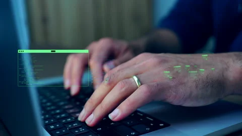 Developer hands typing on laptop keyboard with holographic source code and Stock Footage 335183853