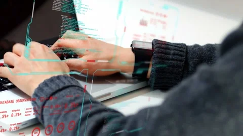 Developer hands typing on laptop keys at desk, HUD graphics syncing with motion Stock Footage 334465930