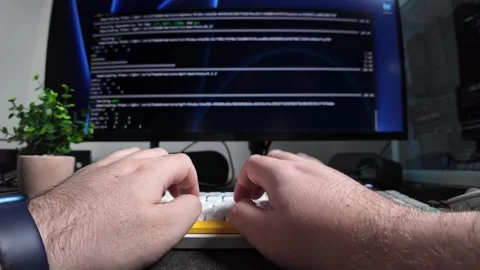Developer hands typing on a modern keyboard with a computer monitor display.. Stock Footage 320174415