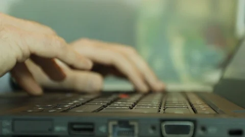Developer hands writing with laptop pc without mouse trackpad in his cubicle Video stock 85760701