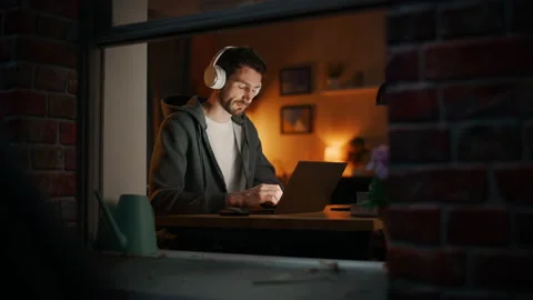 Developer In Headphones Typing At Laptop Video stock 197421127