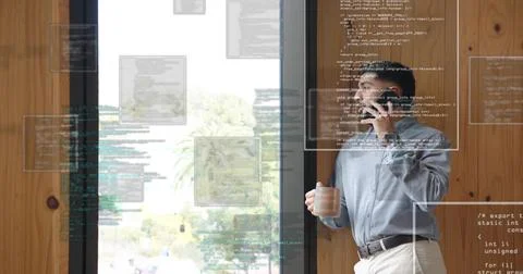 Developer holding coffee mug and smartphone by office window with code overlays, Stock Photos