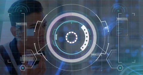 Developer holding smartphone up to face in high tech lab, with HUD and data Stock Photos