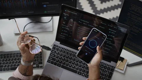 Developer Holding Smartphone with Voice Assistant App at Office Desk Stock Footage 337483518