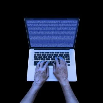 A developer in informatics is using a laptop to code in binary system at night 스톡 사진