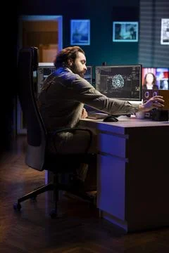 Developer inserting disk into PC containing language data models for AI Stock Photos