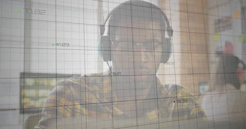 Developer interpreting grid with numeric readouts on laptop at office, with 스톡 사진