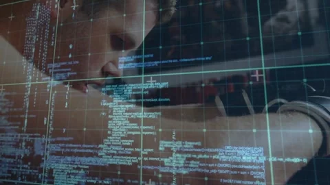 Developer leaning over desk after data feed appears on monitor, reading code Stock Footage 323372457