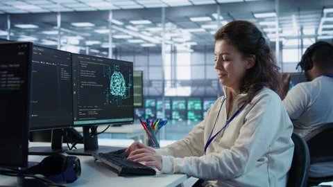 Developer listening music while programming in AI data center Stock Footage 319248999