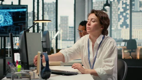 Developer listening music while working in AI startup Stock Footage 323406896