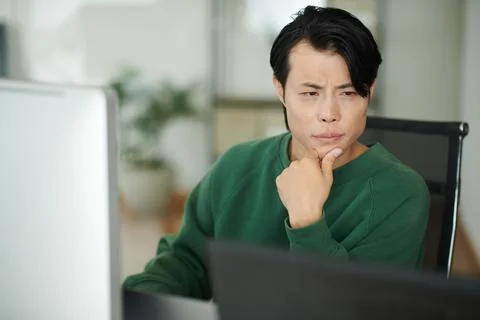 Developer Looking at Laptop Screen Stock Photos