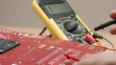 Developer measuring electronic parameters with multimeter. Stock Footage 70791079