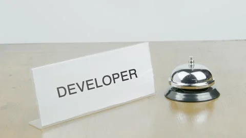 Developer Office or Room with Hand Ringing The Bell on Desk or Table Stock Footage 300664520