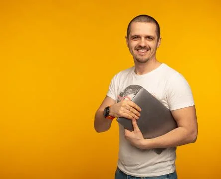 Developer or freelancer man holding laptop and smiling Stock Photos