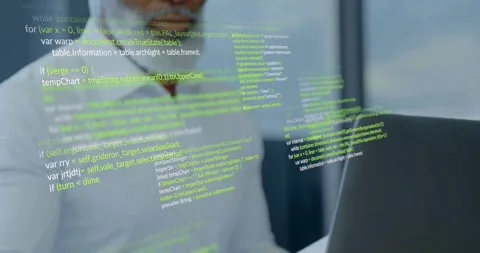 Developer picking up papers and comparing laptop content while verifying code Stock Footage 334039382