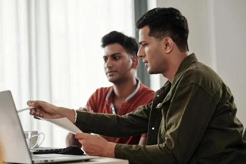 Developer Pointing at Computer Screen Stock Photos