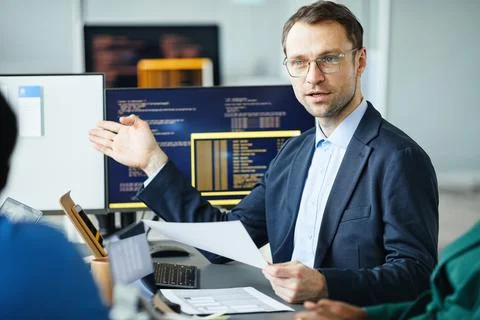 Developer presenting new interface to colleagues Stock Photos