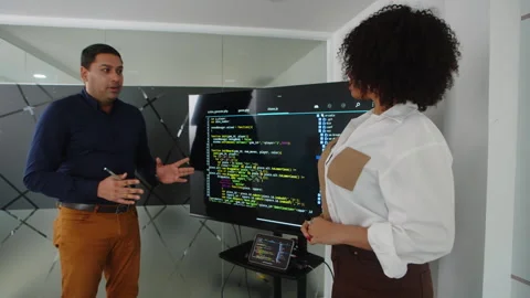 Developer Presenting Script to Manager next to Monitor Stock Footage 263033045