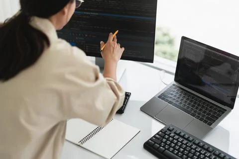 Developer programmer checking code on monitor while programming to developi.. 스톡 사진